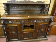 A late 19th Century carved oak sideboard with carved back and shelf with bulbous supports, twin