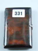 A faux tortoiseshell card case with, possibly silver hinges and an interior hinged bone protector