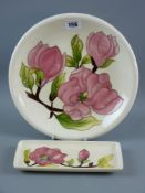A Moorcroft Magnolia cream ground plate, 26 cms diameter, impressed marks and painted 'WM' to the