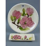 A Moorcroft Magnolia cream ground plate, 26 cms diameter, impressed marks and painted 'WM' to the