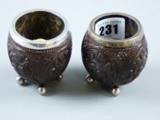 A pair of silver banded carved Oriental kernel bowls each on four ball feet