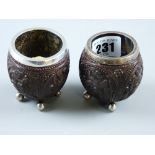 A pair of silver banded carved Oriental kernel bowls each on four ball feet