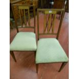 A pair of Edwardian inlaid salon chairs with pierced double 'X' splat having carved central roundels