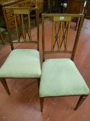 A pair of Edwardian inlaid salon chairs with pierced double 'X' splat having carved central roundels
