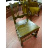 A late 18th Century farmhouse oak rocking chair of plain format with pierced and shaped back