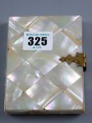 A mother of pearl visiting card case with yellow metal clasp and interior paper divisions