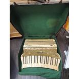 A vintage Hohner piano accordion of cream celluloid fretwork design in original case