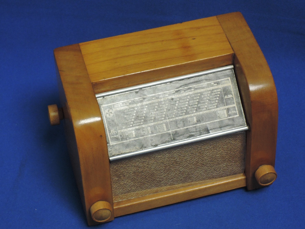 A 1950's Swiss satinwood carved novelty musical cigarette dispenser, modelled as a radio/wireless