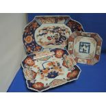 An Imari charger of square chamfered shape having traditional palette, a similar smaller plate and