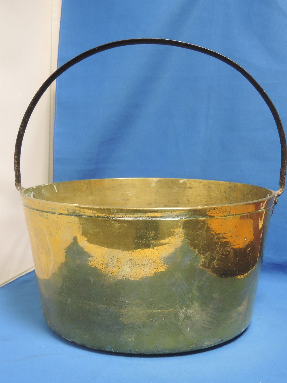 An early 20th century brass jam pan having iron handle