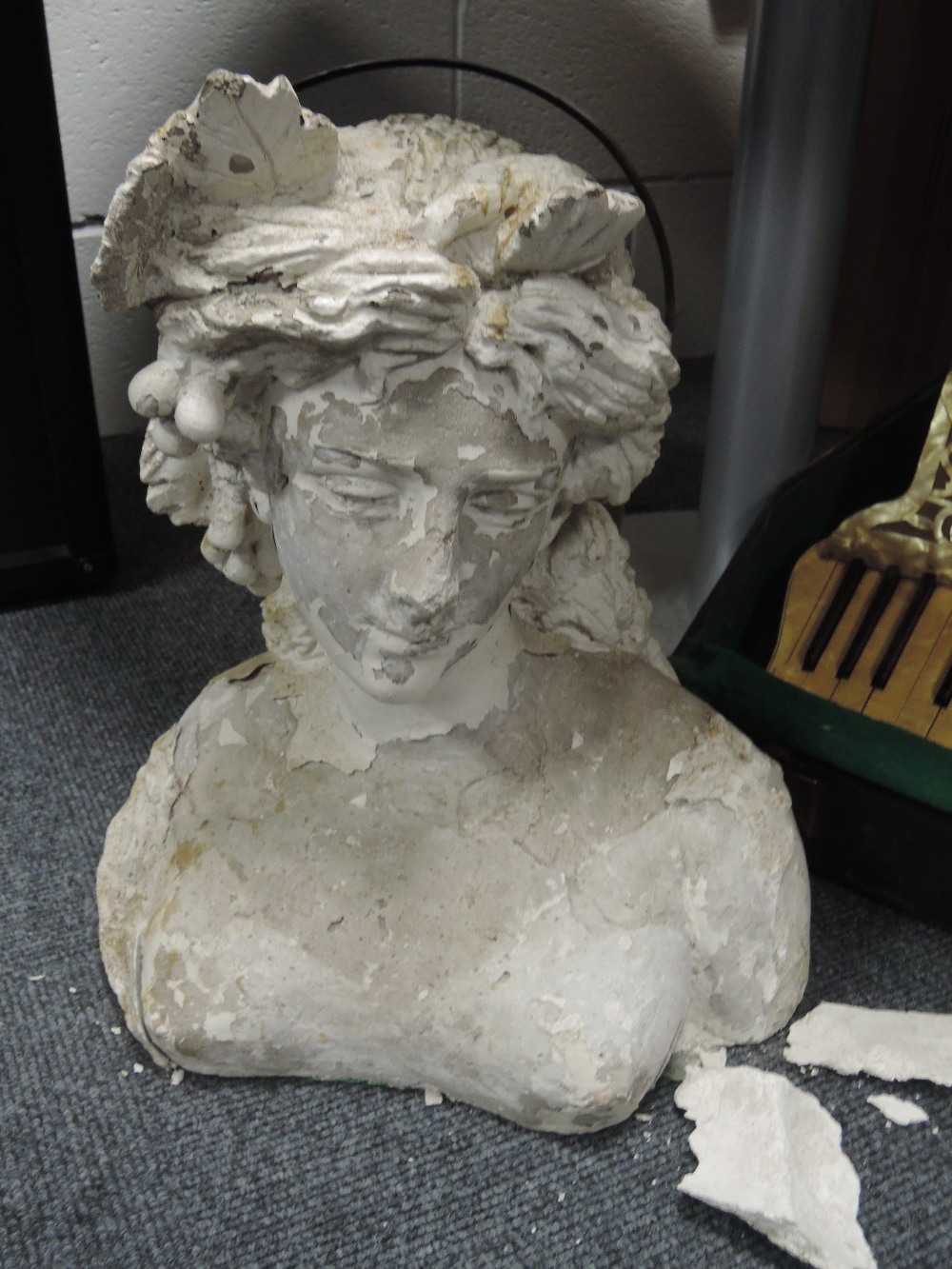 A cast concrete figure modelled as a classical maiden