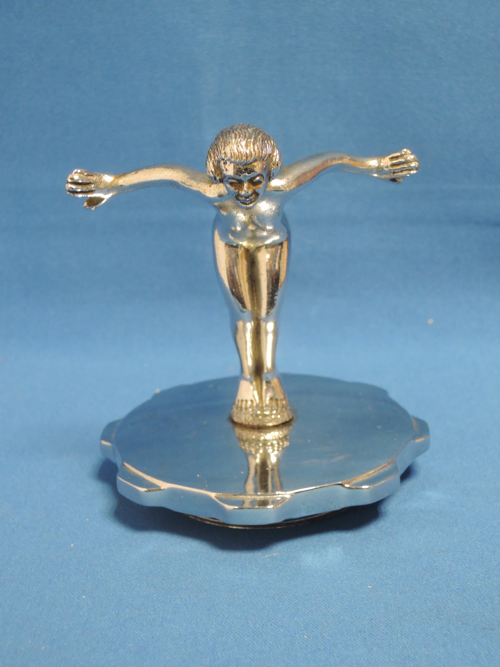 A 1920's chromium car mascot/radiator cap modelled as naked gymnastic woman, numbered 818