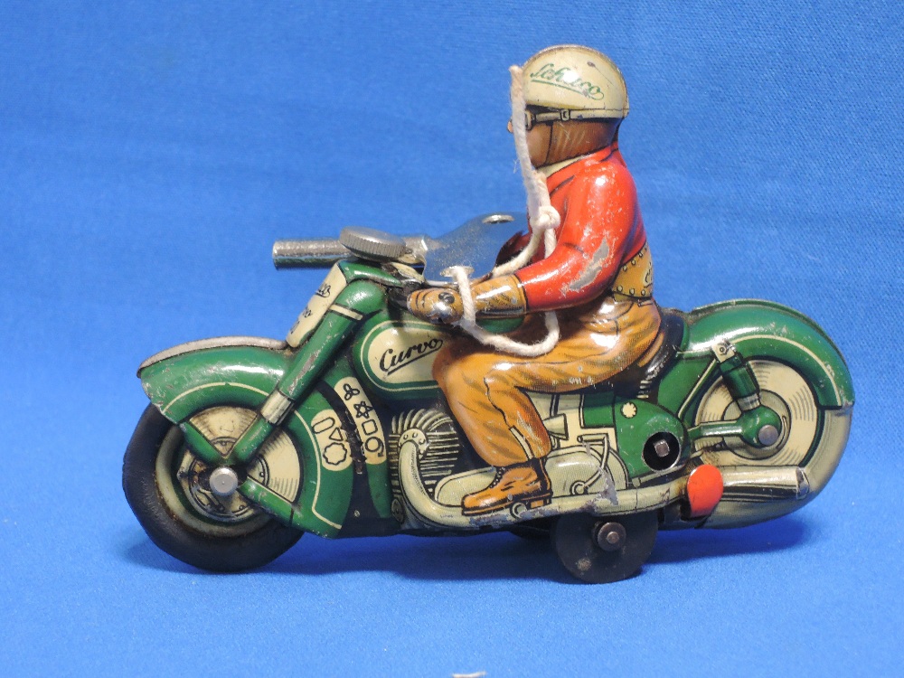 A 1950's Schuco tin plate and clockwork motorcycle with rider Curvo 1000 with key