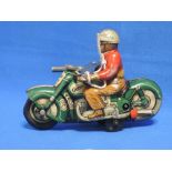 A 1950's Schuco tin plate and clockwork motorcycle with rider Curvo 1000 with key