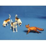 Four Beswick figurines modelled as Three Foxhounds, 944, 2264, 2262, and Fox 1440