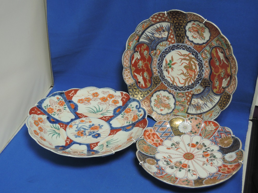 Three Imari chargers of circular scallop shape having traditional palette