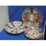 Three Imari chargers of circular scallop shape having traditional palette