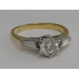 A ladies dress ring having a diamond solitaire, approx .75ct  in a raised claw setting with a