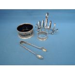 A small silver toast rack of boat form, London 1904, George Gates Honour, a silver salt of