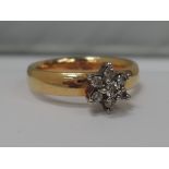 A 22ct gold wedding band having a small diamond cluster addition,  approx 5.6g