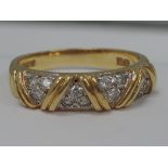 A ladies band style dress ring having diamond chip decoration on an 18ct gold loop