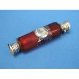 A cranberry glass double ended scent bottle having white metal collar fitments (AF)