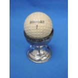 A silver golf trophy modelled as an egg cup with club decoration and inscribed Dunlop Gold Ball hole