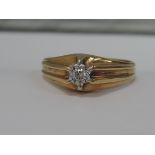 A gents yellow metal signet ring stamped 18ct having an inset diamond