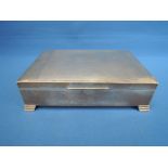 A silver cigarette box of rectangular form having engine turned decoration and plain cartouche,