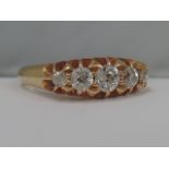 An Edwardian ladies five stone graduated diamond dress ring in a raised gallery setting on an 18ct