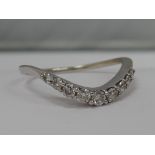 A ladies wishbone style 9 stone graduated diamond ring on an 18ct white gold loop