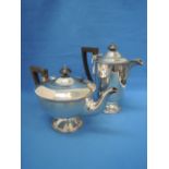 A silver teapot and coffee pot having gadrooned decoration to rims, circular pedestal feet and