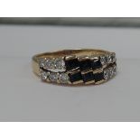A ladies dress ring having six baguette cut sapphires within a double row of diamonds on a yellow