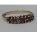 A five stone graduated ruby eternity ring interspersed by diamond chips on a 9ct gold loop