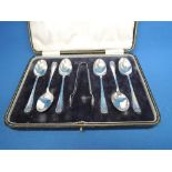 A cased set of six silver teaspoons with matching sugar nips having foliate sprig decoration,