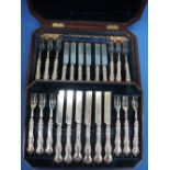 A Victorian canteen of 12 pairs of silver dessert knives and forks having scroll moulded