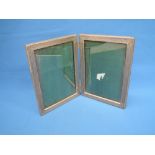 A double photograph frame having white metal surrounds with engraved decoration stamped 800,  wooden