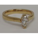 A ladies dress ring having a marquise cut diamond solitaire,  approx .45ct in a collared mount on an