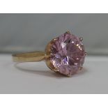 A ladies dress ring having a large pink cubic zirconia on a 9ct gold loop