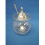 A glass preserve pot having floral cut decoration with a silver lid, London 1922, with plated spoon,