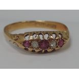 A ladies dress ring having three rubies interspersed by two diamonds in a gallery mount with