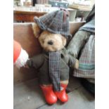 A Laura Grant bear wearing jacket, hat, scarf and wellingtons