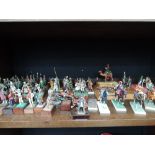 A shelf of cold cast and plastic military figures and animals