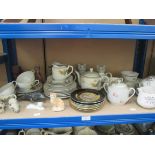 A shelf of decorative ceramics, including cat figurines etc