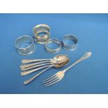 Four HM silver napkin rings of various designs, a part set of HM silver teaspoons and a child's HM