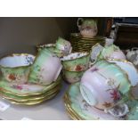 A Victorian tea service having gilt heightened floral decoration