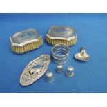 A selection of HM silver including thimbles, napkin ring, clothes brushes, caddy spoon etc