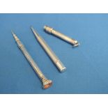 An HM silver propelling pencil having engine turned decoration, a white metal propelling pencil