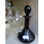 A cut glass fruit basket and glass decanter of magenta form