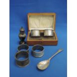 Five HM silver napkin rings of various styles including cased, an HM silver jam spoon and a